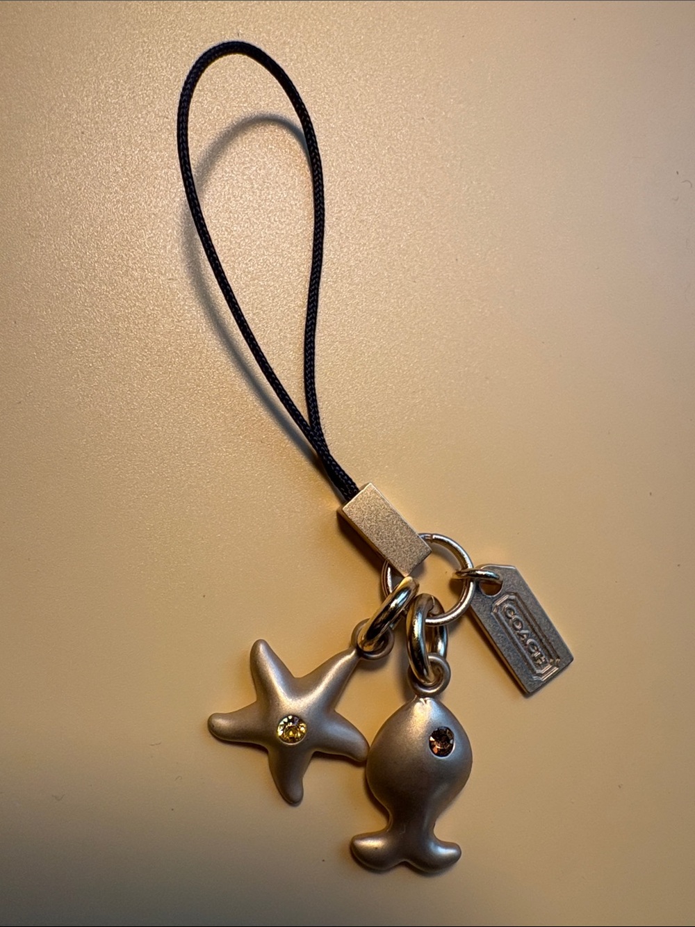Coach Gold-Tone Fish & Starfish Charm Strap with Logo Tag